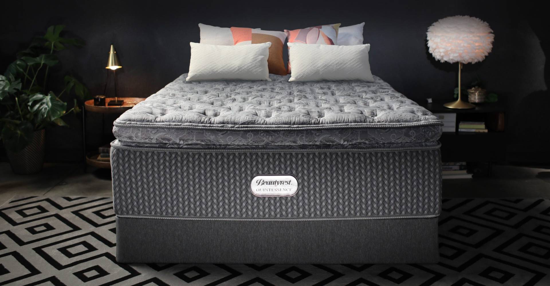 Beautyrest Quintessence mattress in a dim bedroom between two bedside tables with lamps